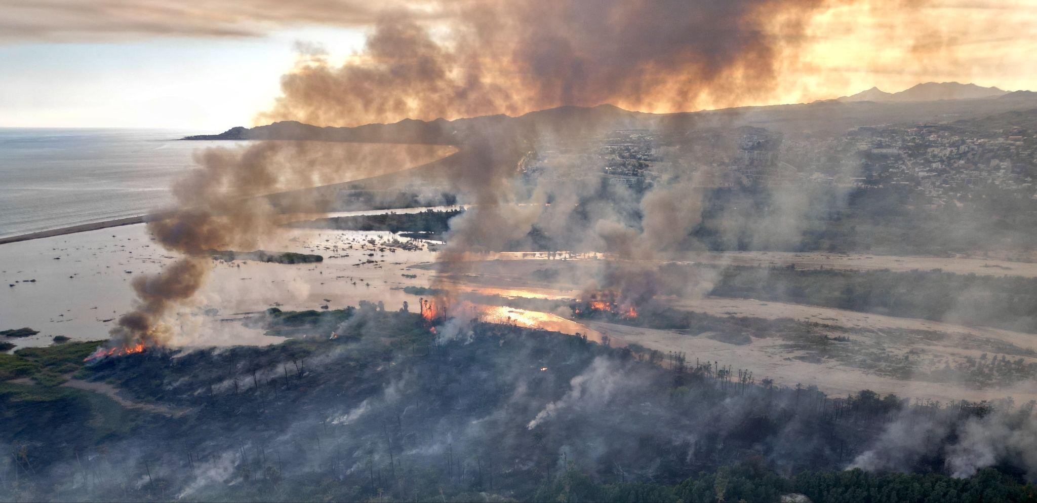 Aerial view of fire burning through the Añuiti Estuary