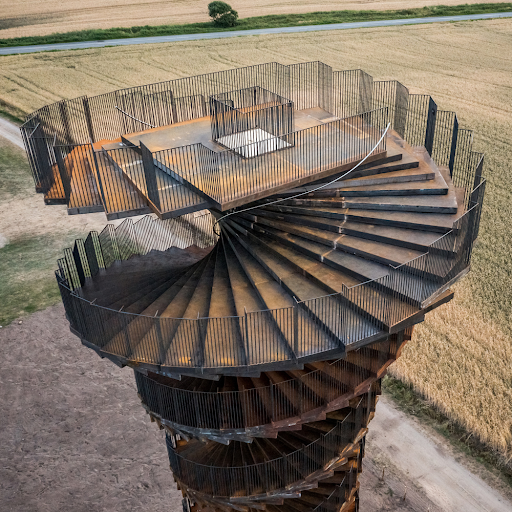 Aerial view of the Marsk Tower by BIG — spiral observation tower in the Danish Wadden Sea, the direct precedent for the Osprey Posadero Design Challenge